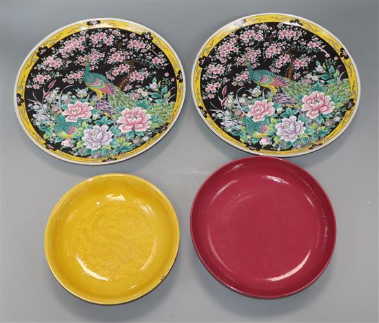 A Chinese ruby ground dish and a yellow dragon dish and two others largest diameter 26cm